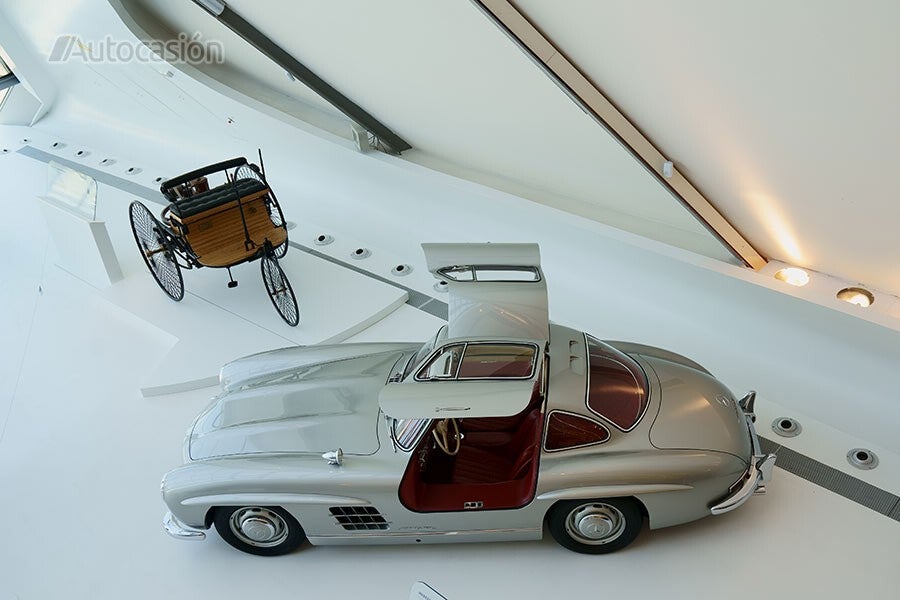 The Daimler trike and the Mercedes 300SL are posed together in Mobility City.