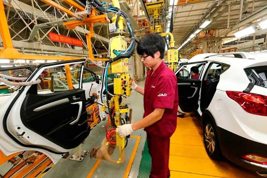 Chinese worker in a car factory